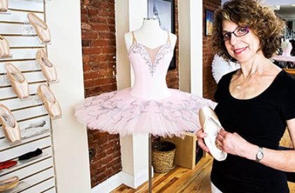 Grishko Manager Judy Weiss in shop with tutu and pointe shoes