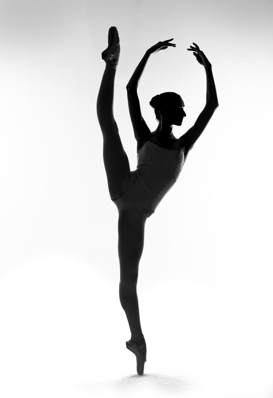 silhouette of graduate Amber Miller on pointe with leg extended